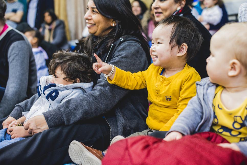 A diverse audience looks on at a show